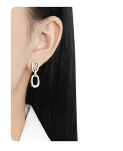 Close-up of minimalist S925 sterling silver double-hoop earrings worn by a model