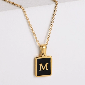 Minimalist square pendant necklace in gold stainless steel with black enamel letter M