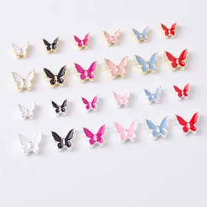Macro shot of colorful alloy butterfly nail charms in various sizes and vibrant colors