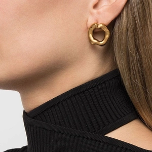 Irregular geometric 18K gold plated stainless steel hollow lava earrings on a model
