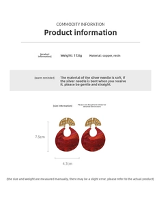 Detail view of red resin hoop earrings with gold metal accents showing size 7.5cm by 4.7cm
