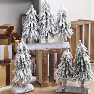 Mini Christmas tree with flocked snow effect, LED lights, and natural wooden base décor