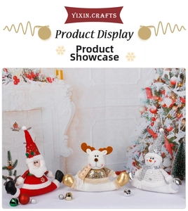 Three Christmas plush dolls with gold sequins in a cozy holiday home fireplace setting