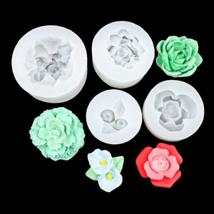 Floral silicone molds for fondant showing rose and succulent patterns on black background