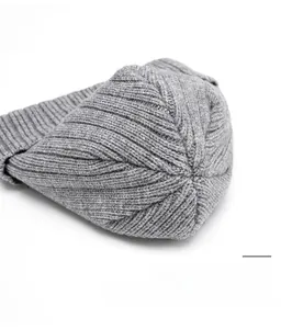 Macro detail of high-quality grey knit beanie top with durable reinforced stitching