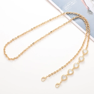Close-up of gold chain strap with five heart-shaped crystals and lobster clasps