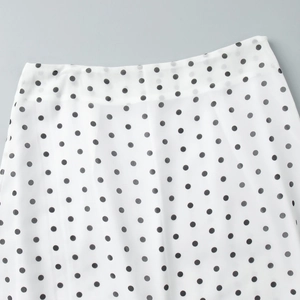 Detailed macro view of the waistline on a white polka dot chiffon maxi skirt