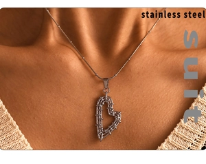Detail of silver heart-shaped pendant with a deconstructive mesh texture on stainless steel