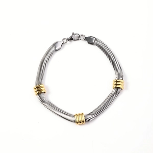 Two-tone stainless steel 6mm herringbone chain bracelet with gold-toned ribbed bead accents