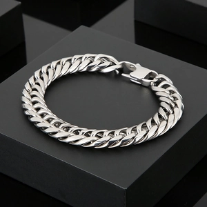 Detailed view of silver polished stainless steel Cuban link bracelet with lobster clasp