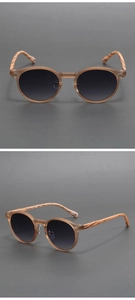 Close-up of vintage round matte brown sunglasses with wood-texture arms and gradient lenses