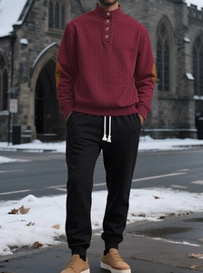 Detail of burgundy textured stand collar tracksuit with brown elbow patches and joggers