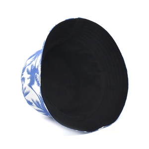 Detail showing the reversible design with black lining and palm tree print bucket hat