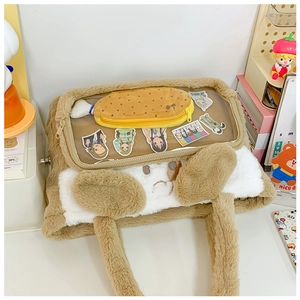 Close-up of plush cartoon cat shoulder bag with clear PVC window and anime decorations
