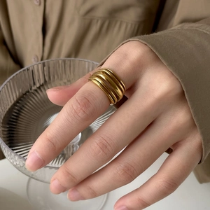 Detail of a gold multilayer wrap ring with a minimalist polished stacked design