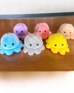 Detailed view of reversible plush octopus keychains showing multiple colors and materials