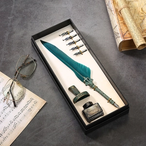 Vintage green feather quill pen set with ink, metal base and five replacement nibs