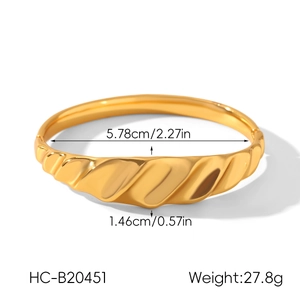 Detailed view of wide 18k gold plated stainless steel cuff with ribbed texture and size