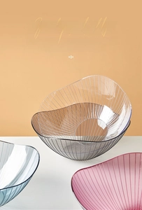 Close-up of modern PET plastic fruit plates with vertical stripes and multi-color transparency