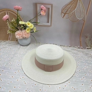 Elegant women's boater straw hat with wide pink ribbon and square buckle detail