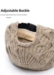 Detail view of the adjustable black plastic buckle strap on a chunky knit baseball cap