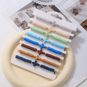 Eight-piece Bohemian cross bracelet set with colorful polymer clay beads and metal charms