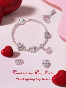 Detail of silver snake chain bracelet with pink heart charms and sentimental engravings