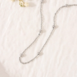 Minimalist silver titanium steel necklace featuring small beads on a fine chain design