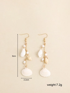 Detail view of shell and pearl drop earrings with measurement labels 9cm length and weight 7.2g