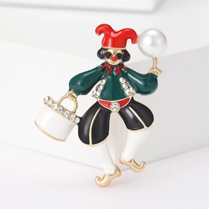 Detailed view of enamel clown brooch with colorful crystals and a large white faux pearl