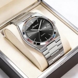 Detailed close-up of a men's silver steel quartz watch with black dial in a display box