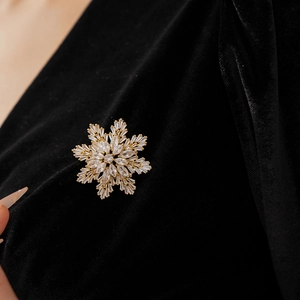 Detail shot of snowflake brooch with gold plating and brilliant marquise cut zircons