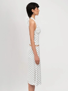 Detail of white polka dot crop halter top and midi skirt set with backless tie design
