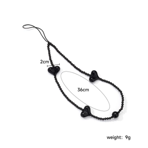 Handmade 36cm black beaded phone strap with 2cm heart charms on white background