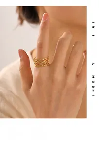 Close-up of leaf textured 18K gold plated stainless steel ring on a model's finger