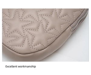 Detailed close-up of elephant gray leather bag featuring star quilting and fine stitching