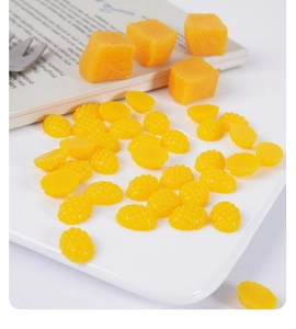 Detailed macro view of 1.5cm miniature yellow resin mango cubes for DIY craft making
