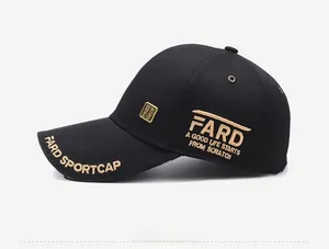 Detail of black baseball cap with golden embroidery and metal badge on cotton fabric