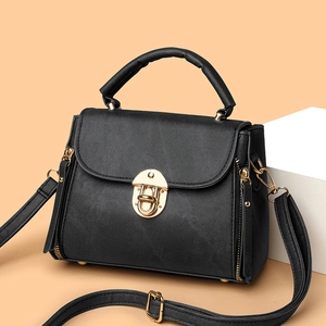 Classic black crossbody bag with gold hardware and top handle shown in 45-degree angle