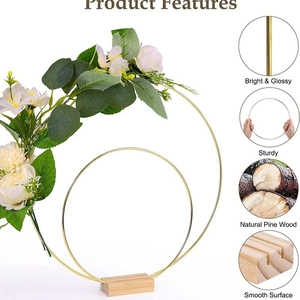 Golden double metal ring centerpiece with white flowers on a natural pine wood base