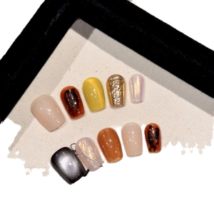 Short square press-on nails set featuring amber tortoise shell and cat eye gold foil design