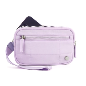 Close-up of quilted lavender wristlet bag showing capacity with a phone inside