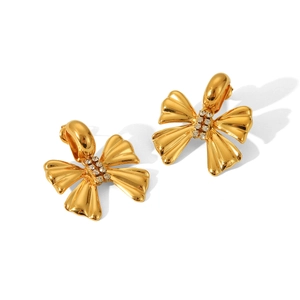 Detailed macro of 18K gold bow earrings with crystal pave and white rhinestones