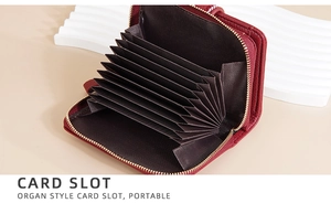 Macro detail of red leather card holder with accordion slots and gold zipper