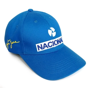 Close-up of NACIONAL letter embroidery and yellow signature on blue cotton baseball cap
