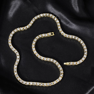 Detailed close-up of 4mm gold tennis chain with round zircons on black silk fabric