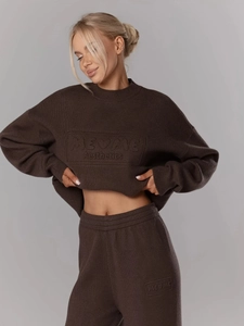 Detailed view of the coffee brown knit set featuring embossed brand lettering and rib texture