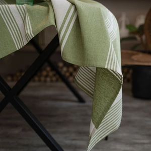 Japanese style green and white striped cotton linen tablecloth on a black metal table