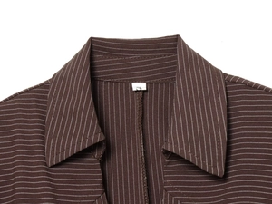 Dettaglio del colletto classico a punta su camicia marrone a righe con etichetta taglia S