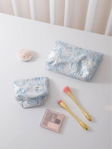 Floral relief makeup bags in light blue jacquard fabric for travel storage